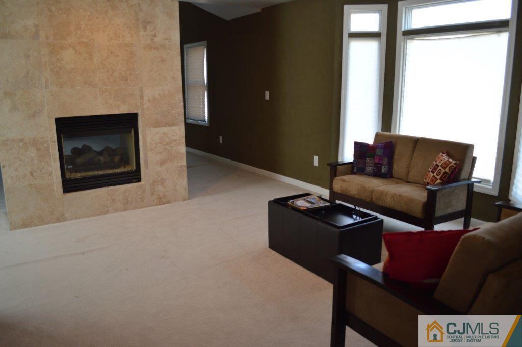 72 Stafford Road Colonia, NJ 07067 - Photo 7 of 20 a living room with furniture and a fireplace