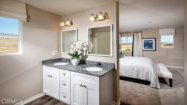 36838 Arietta Way Beaumont, CA 92223 - Photo 11 of 26 a spacious bathroom with a granite countertop sink and a mirror