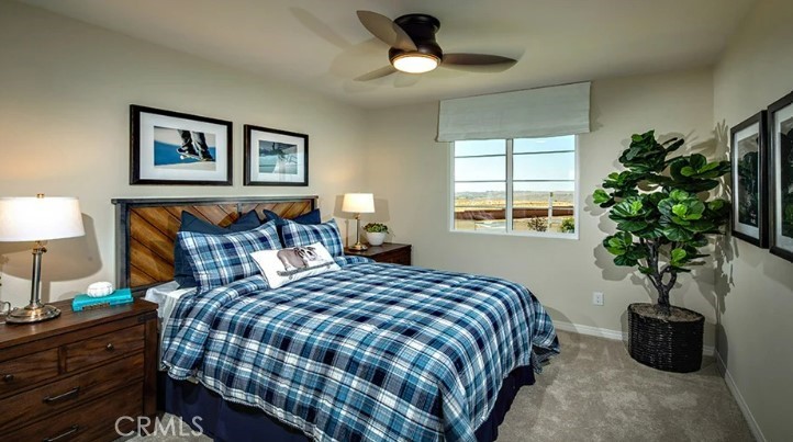 36838 Arietta Way Beaumont, CA 92223 - Photo 15 of 26 a bedroom with bed and a potted plant