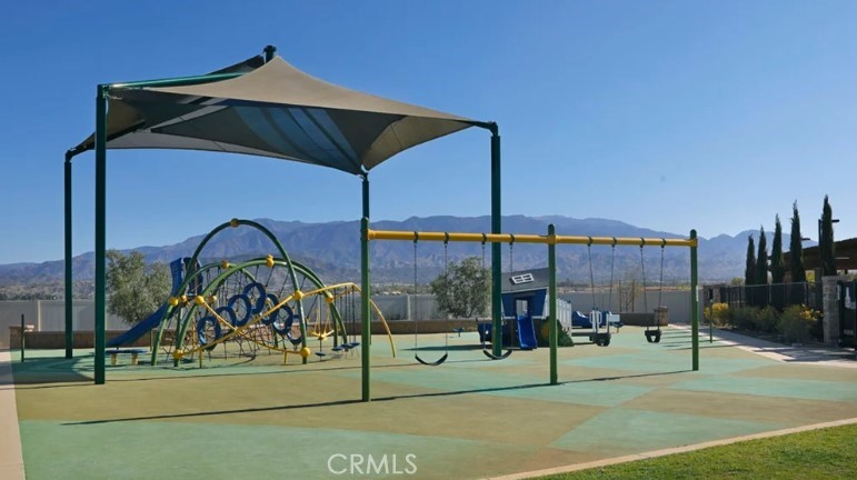 36838 Arietta Way Beaumont, CA 92223 - Photo 20 of 26 a view of tall trees with a chair and table in the patio