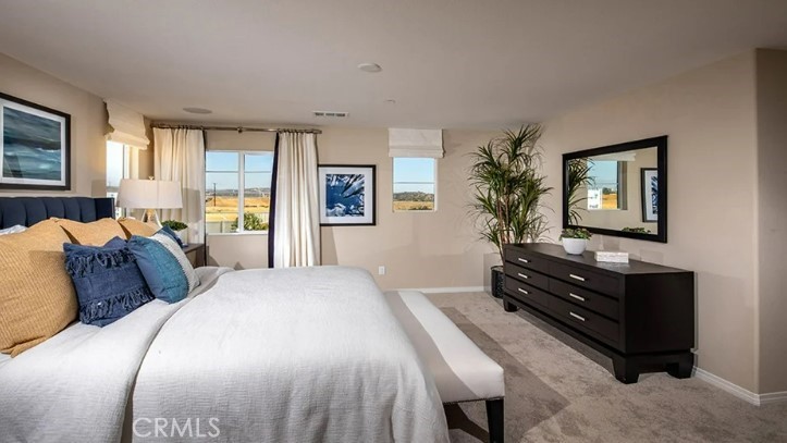 36838 Arietta Way Beaumont, CA 92223 - Photo 10 of 26 a bedroom with a bed and a potted plant