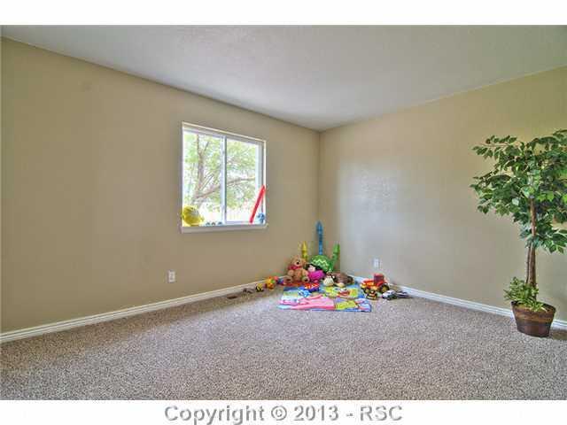 10865 Falling Star Road Fountain, CO 80817 - Photo 12 of 23 Main level 2nd bedroom w/ new carpet & custom paint!