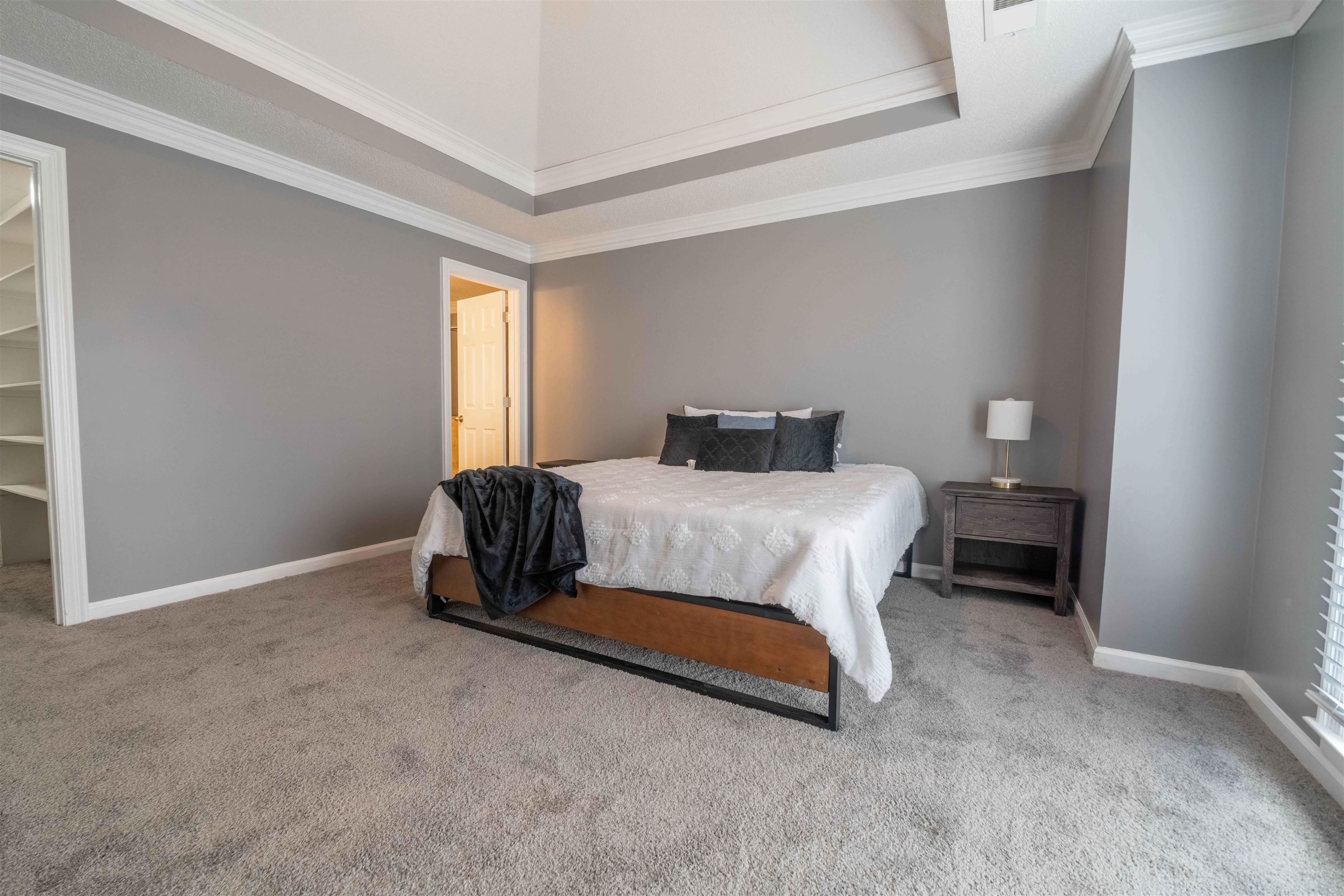 2630 Davies Plantation Road Memphis, TN 38016 - Photo 11 of 37 Carpeted bedroom featuring ornamental molding, a raised ceiling, and a spacious closet