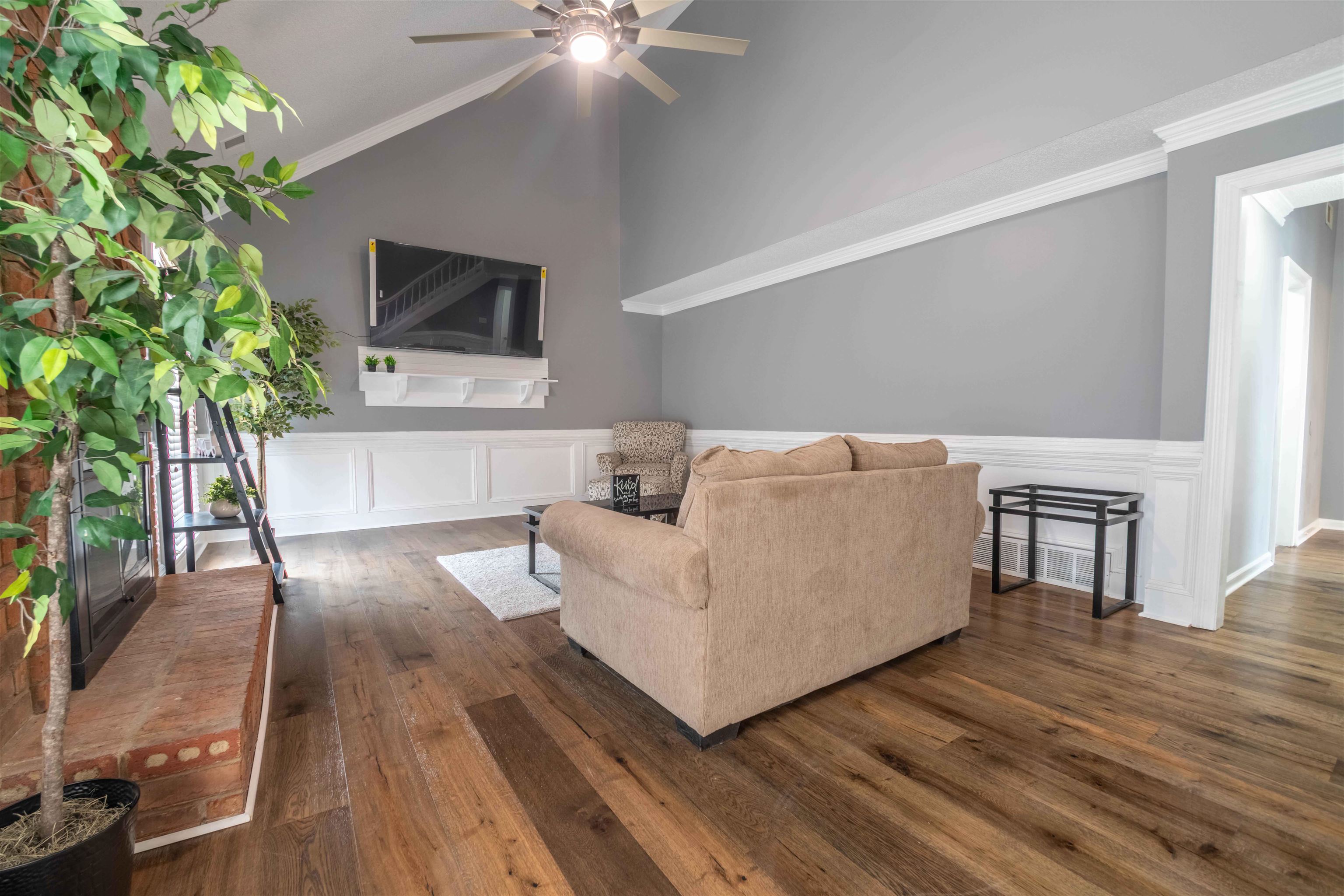 2630 Davies Plantation Road Memphis, TN 38016 - Photo 27 of 37 Living room with crown molding, dark wood finished floors, a wainscoted wall, a decorative wall, and a ceiling fan