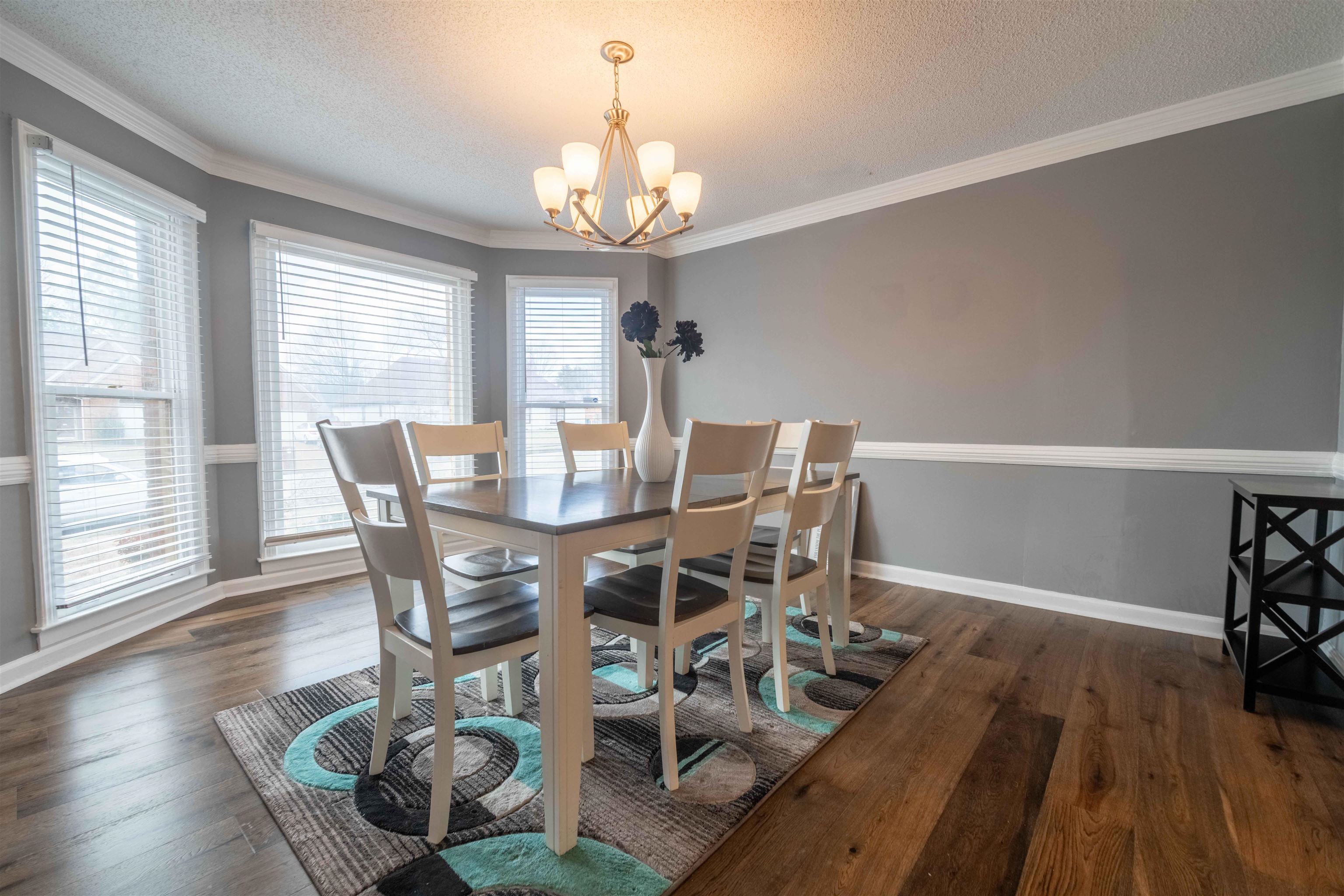 2630 Davies Plantation Road Memphis, TN 38016 - Photo 8 of 37 Dining space with dark wood-style floors, suspended lighting, a textured ceiling, and ornamental molding