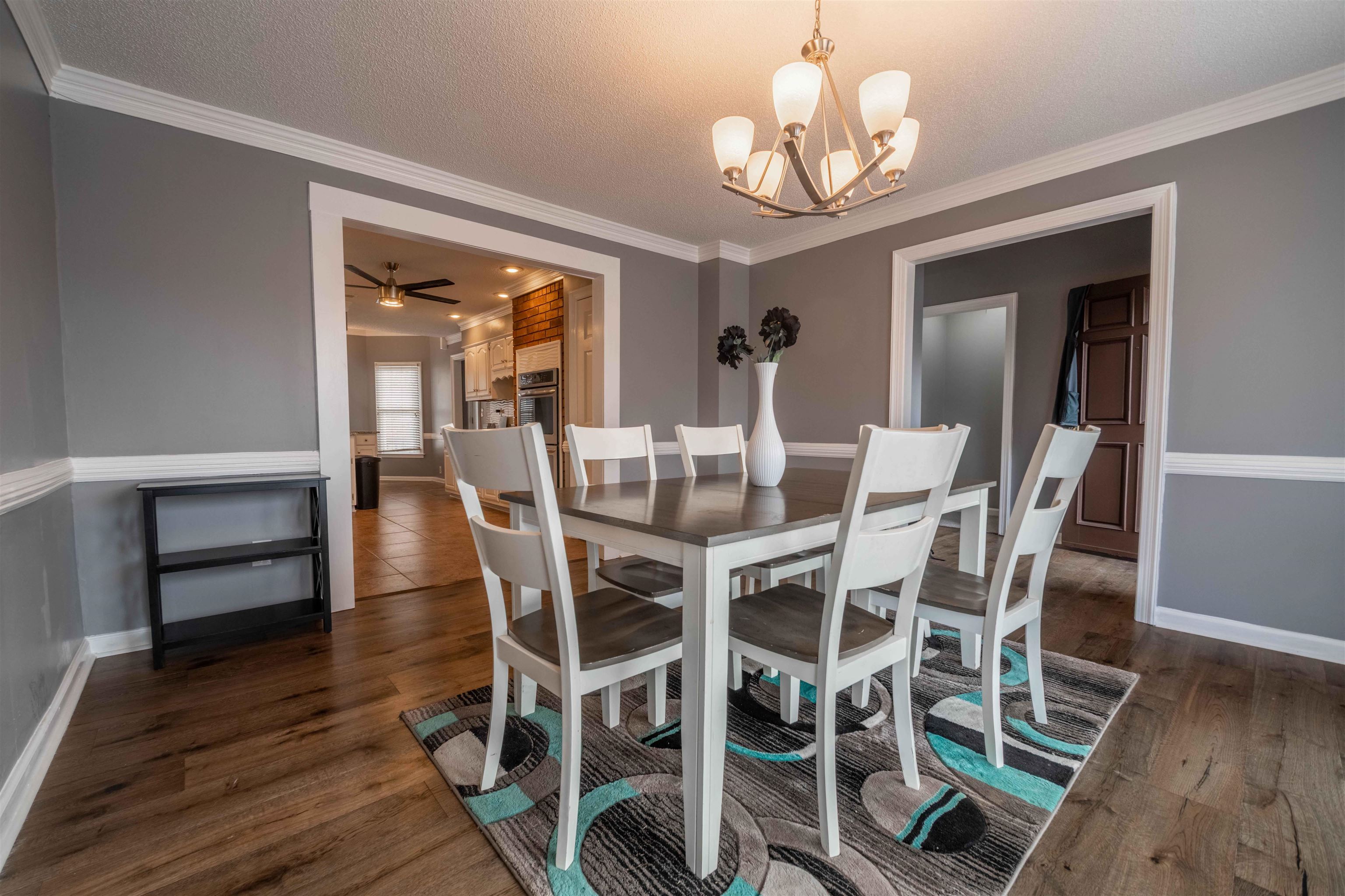 2630 Davies Plantation Road Memphis, TN 38016 - Photo 9 of 37 Dining space with dark wood-style flooring, suspended lighting, crown molding, ceiling fan, and a textured ceiling