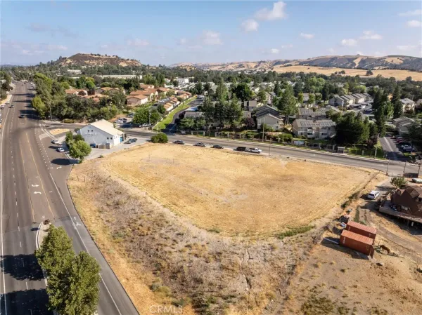 an aerial view of residential houses and car parked on street side
