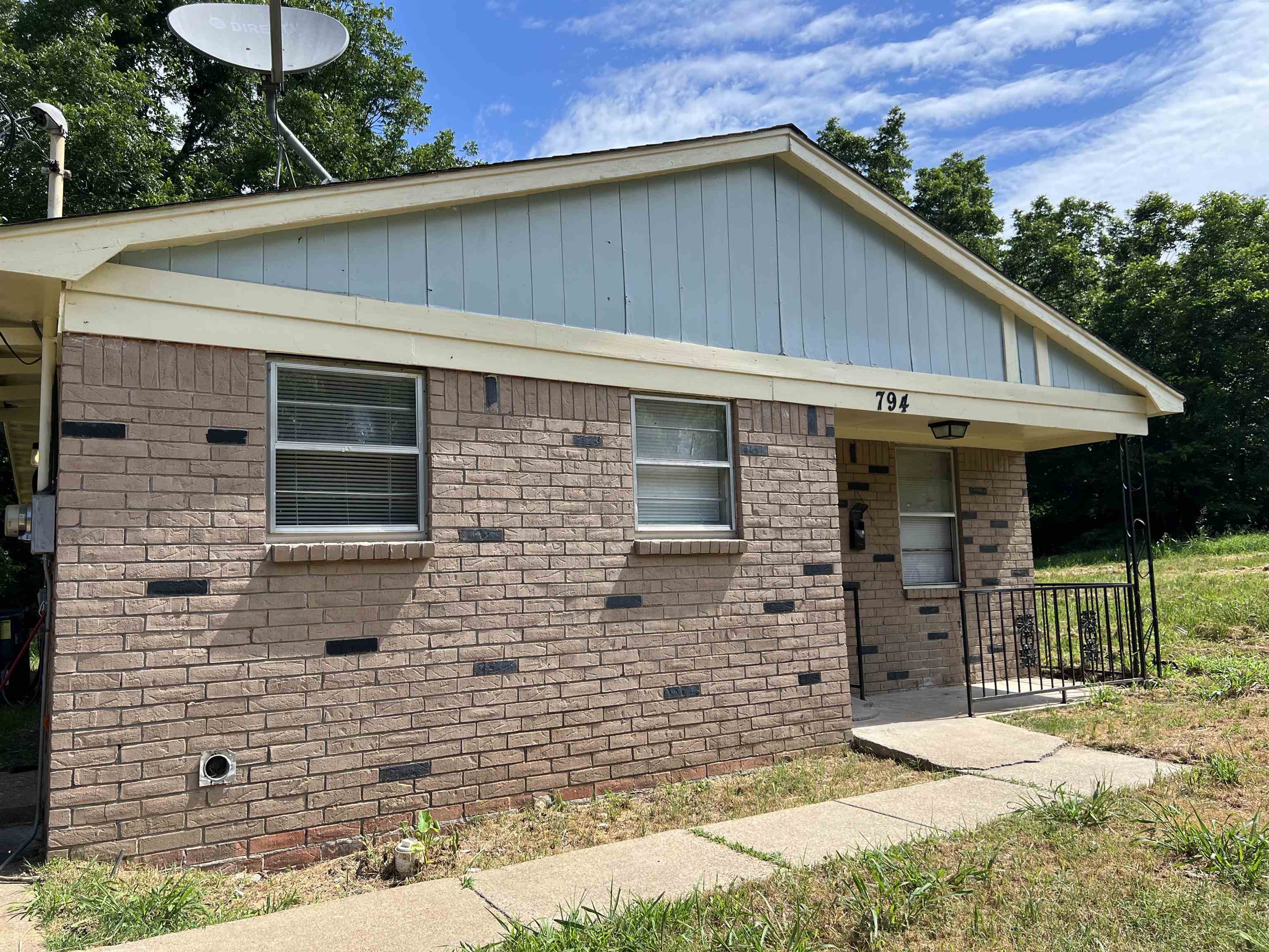 a backyard of a house with dishwasher and outdoor seating