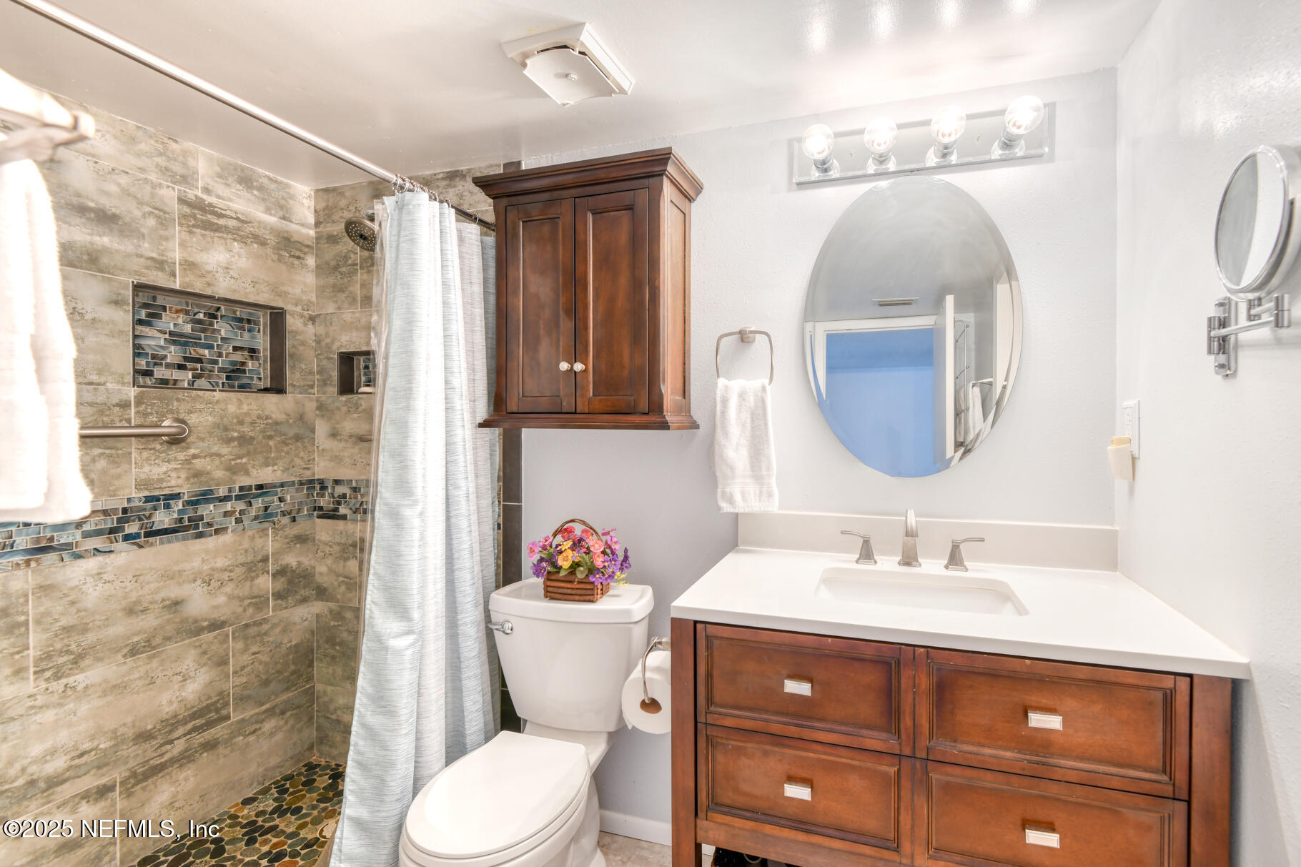 222 River Bend Court, Unit BLDG C Welaka, FL 32193 - Photo 17 of 49 a bathroom with a sink vanity mirror and toilet