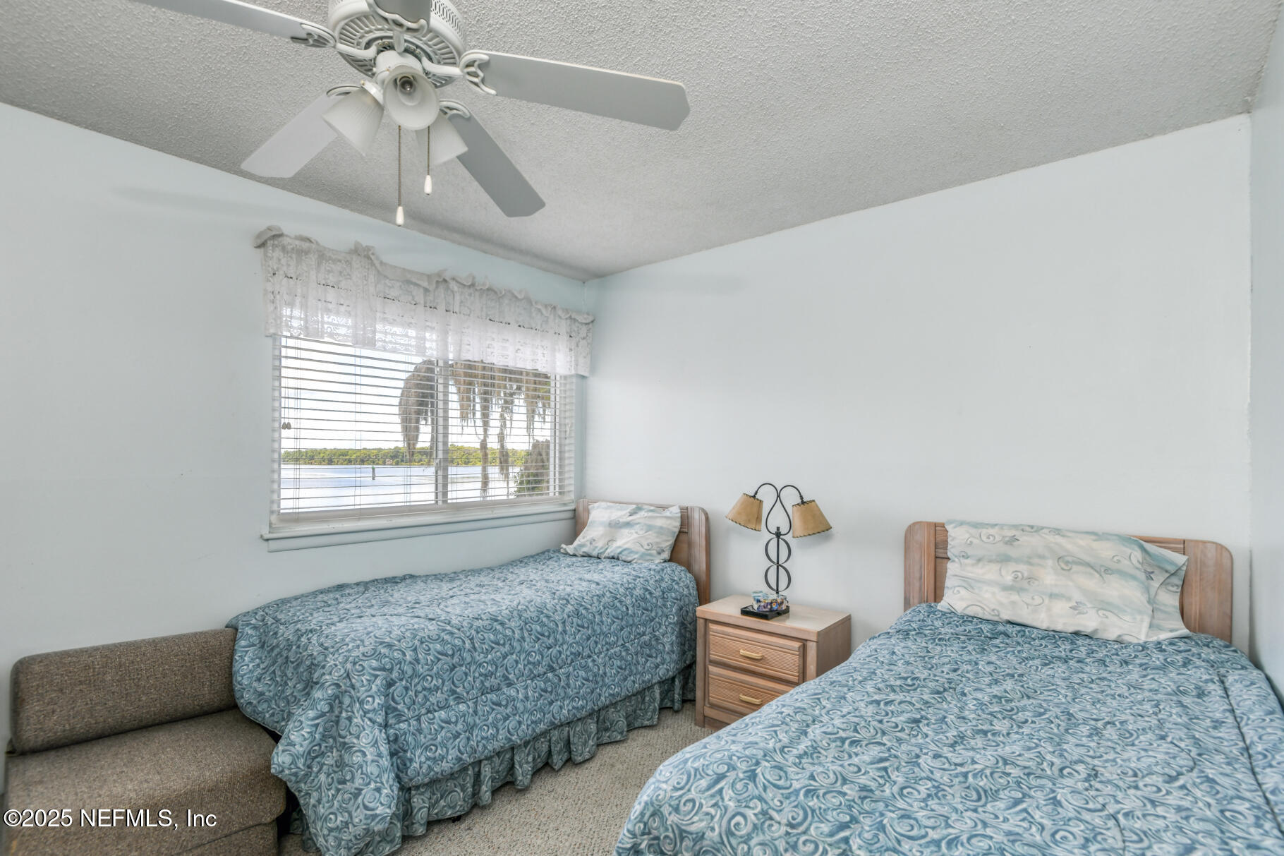 222 River Bend Court, Unit BLDG C Welaka, FL 32193 - Photo 18 of 49 a bedroom with a bed and a chandelier