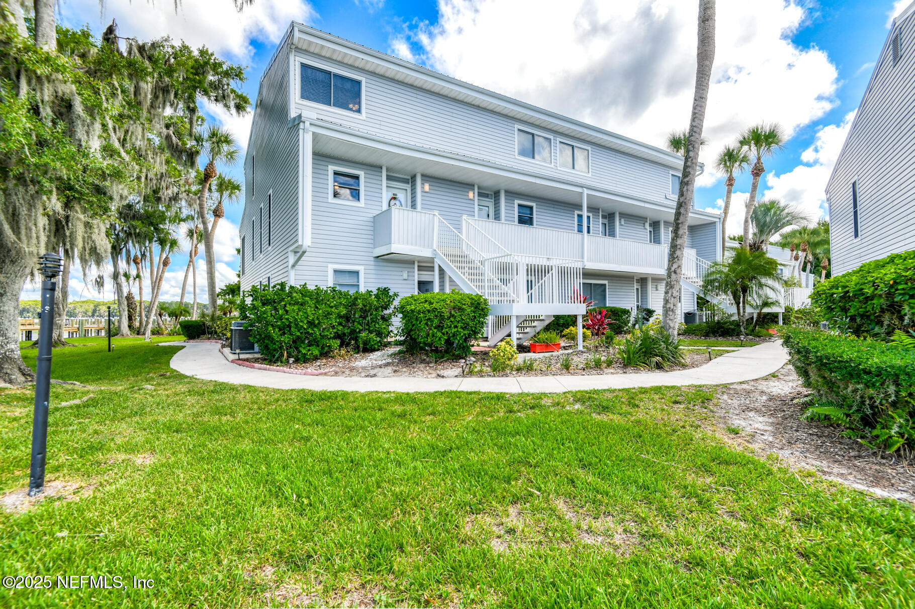 222 River Bend Court, Unit BLDG C Welaka, FL 32193 - Photo 2 of 49 a front view of a house with swimming pool and garden