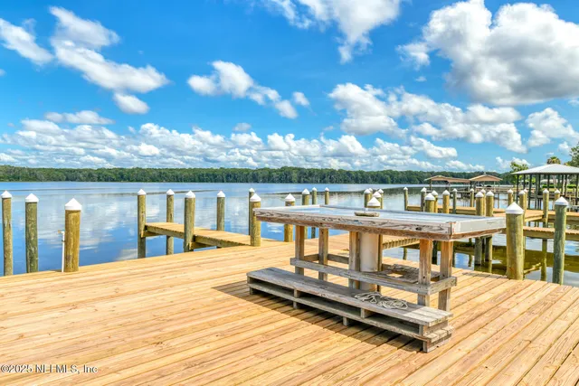 a view of a house with pool and sitting area