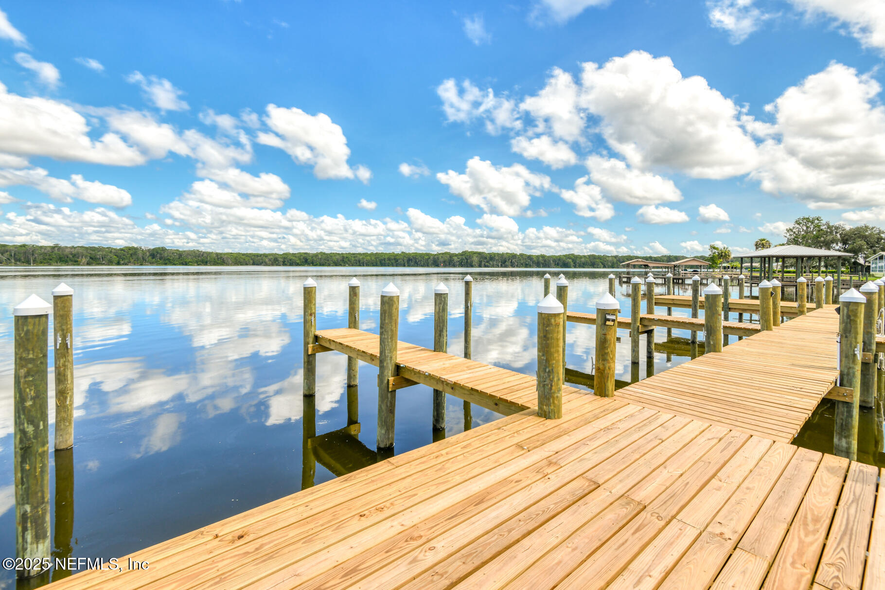 222 River Bend Court, Unit BLDG C Welaka, FL 32193 - Photo 28 of 49 a view of roof deck with two chairs and wooden floor