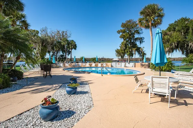 a view of a swimming pool and lounge chair