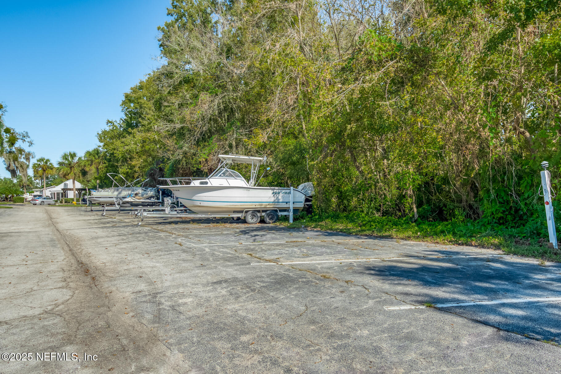 222 River Bend Court, Unit BLDG C Welaka, FL 32193 - Photo 33 of 49 a backyard of a house with trees and outdoor seating