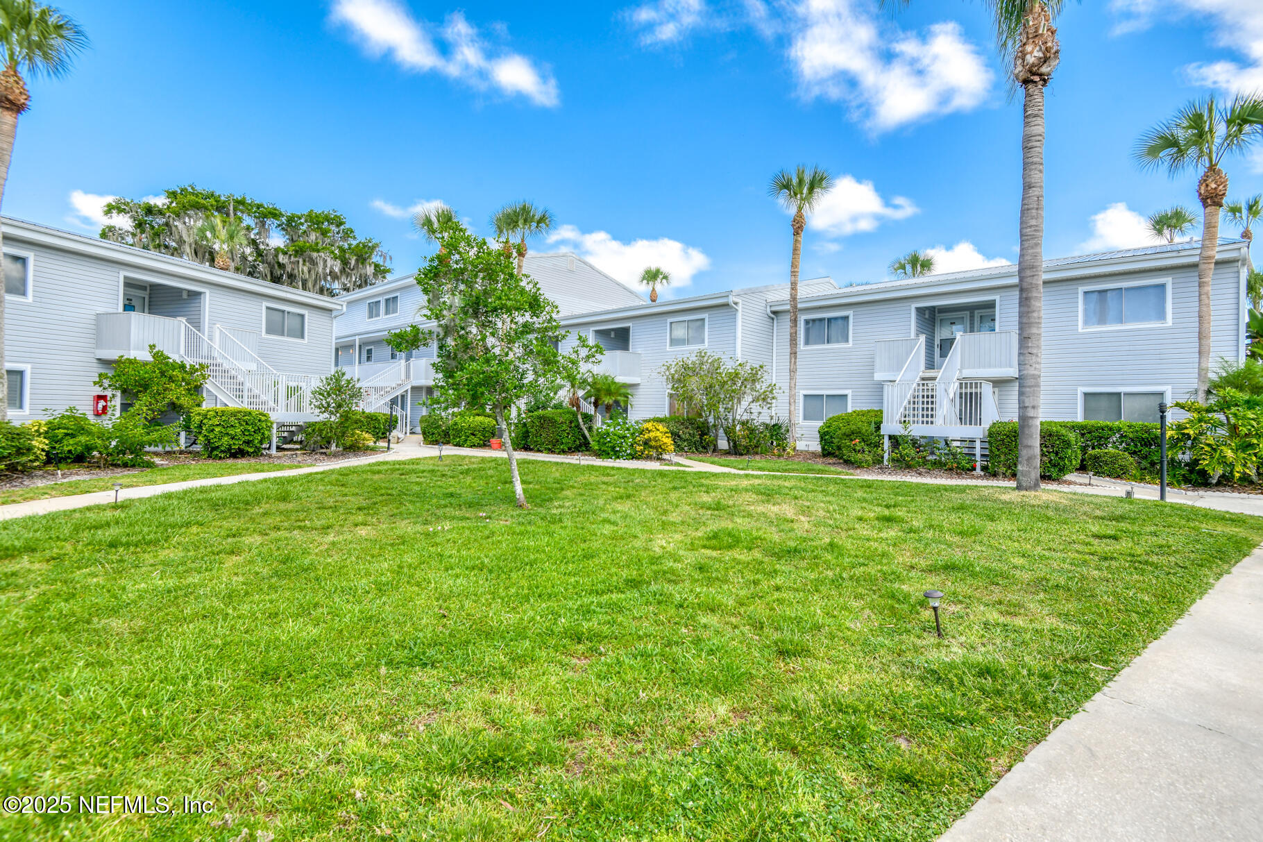 222 River Bend Court, Unit BLDG C Welaka, FL 32193 - Photo 35 of 49 a front view of a house with a yard and potted plants