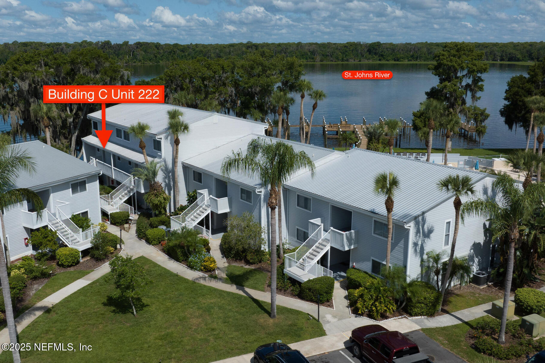 222 River Bend Court, Unit BLDG C Welaka, FL 32193 - Photo 38 of 49 an outdoor space with seating area and car parked