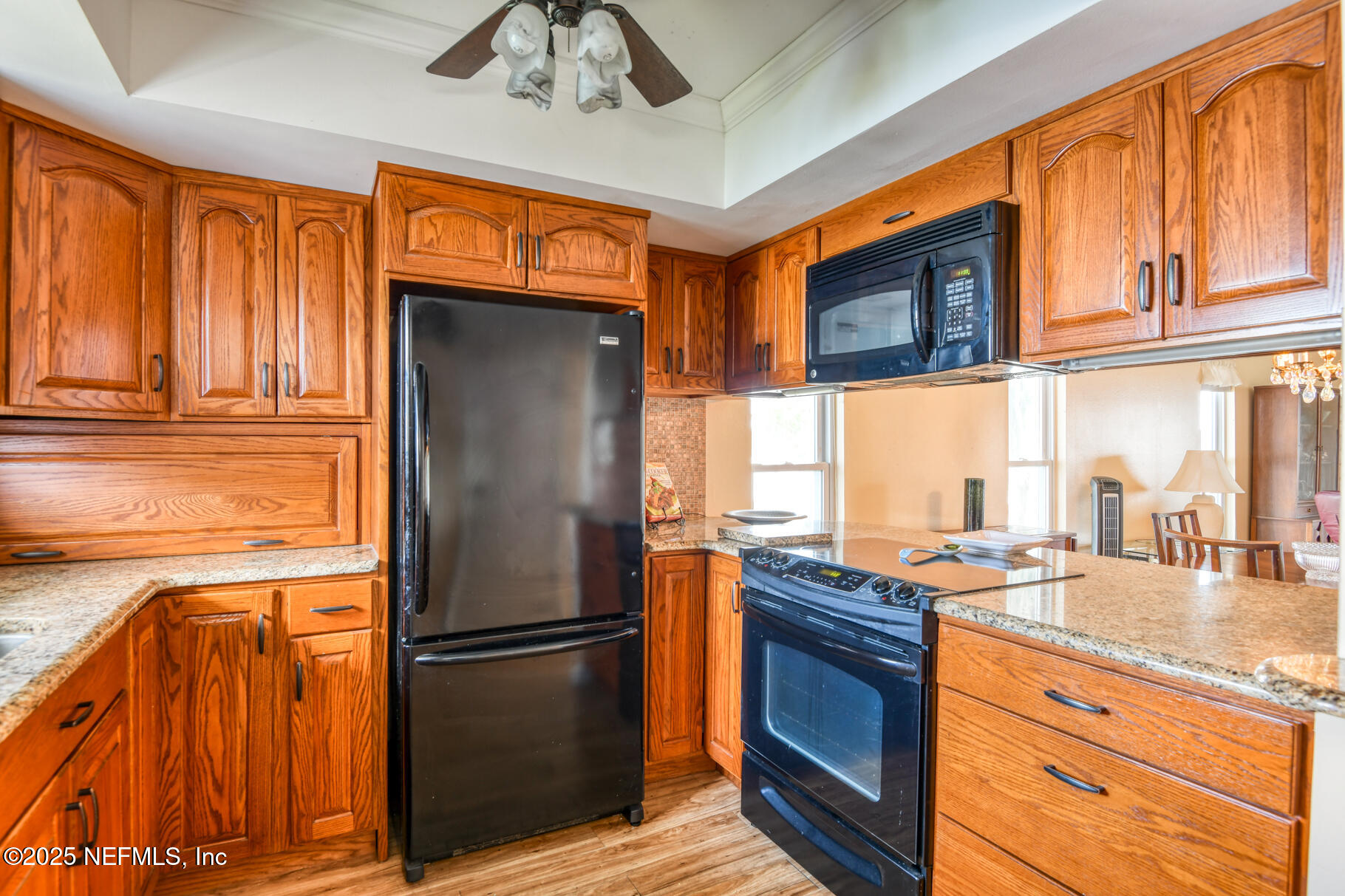 222 River Bend Court, Unit BLDG C Welaka, FL 32193 - Photo 6 of 49 a kitchen with stainless steel appliances granite countertop a refrigerator and a stove top oven