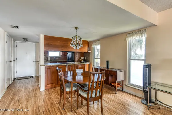 a view of a dining room with furniture and window