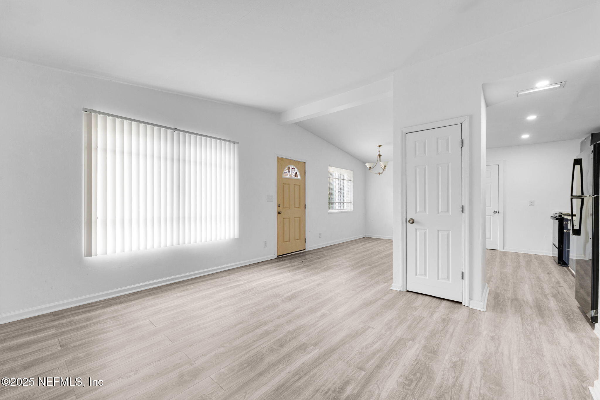 9155 Sibbald Road Jacksonville, FL 32208 - Photo 11 of 22 an empty room with wooden floor and windows