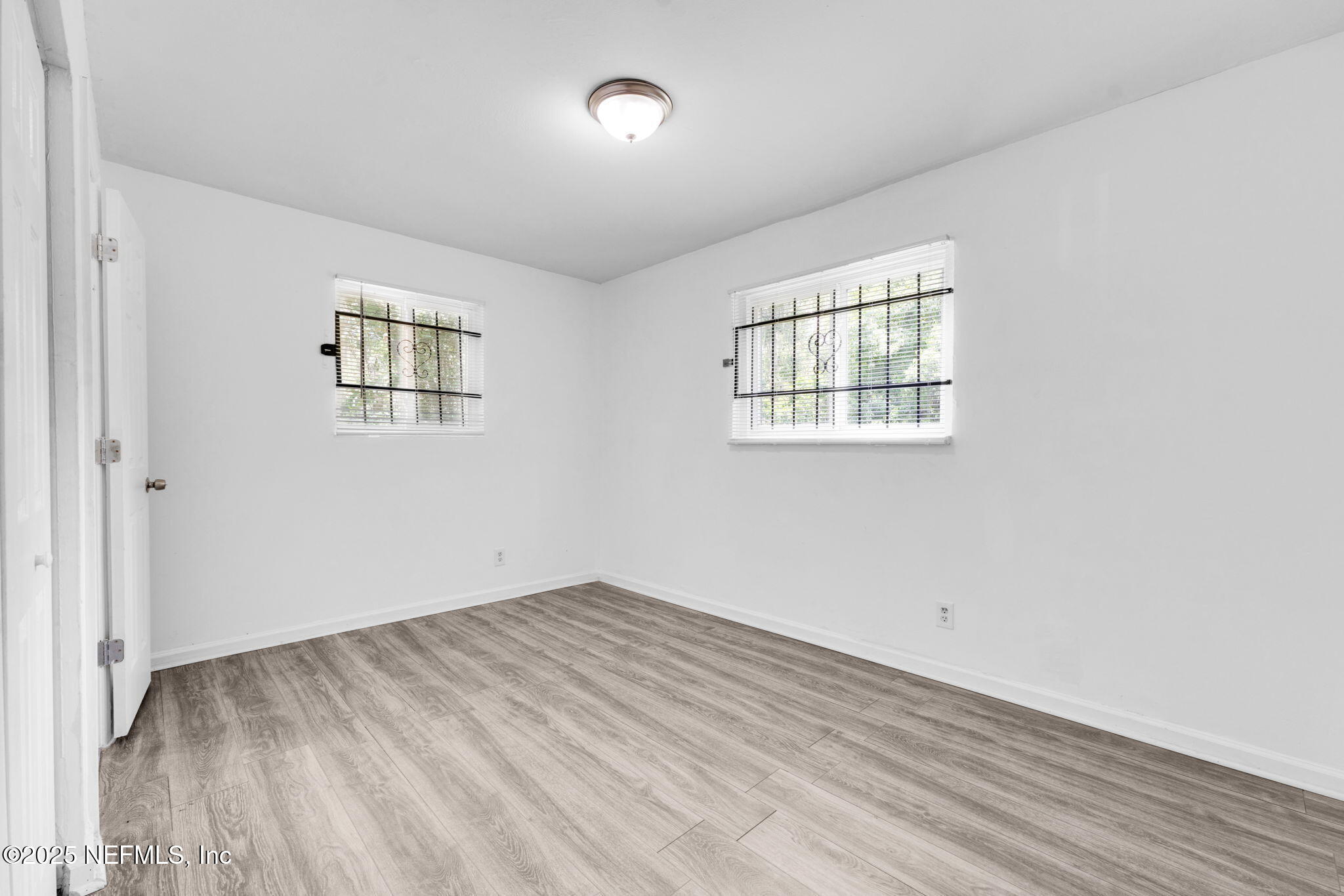 9155 Sibbald Road Jacksonville, FL 32208 - Photo 14 of 22 an empty room with windows