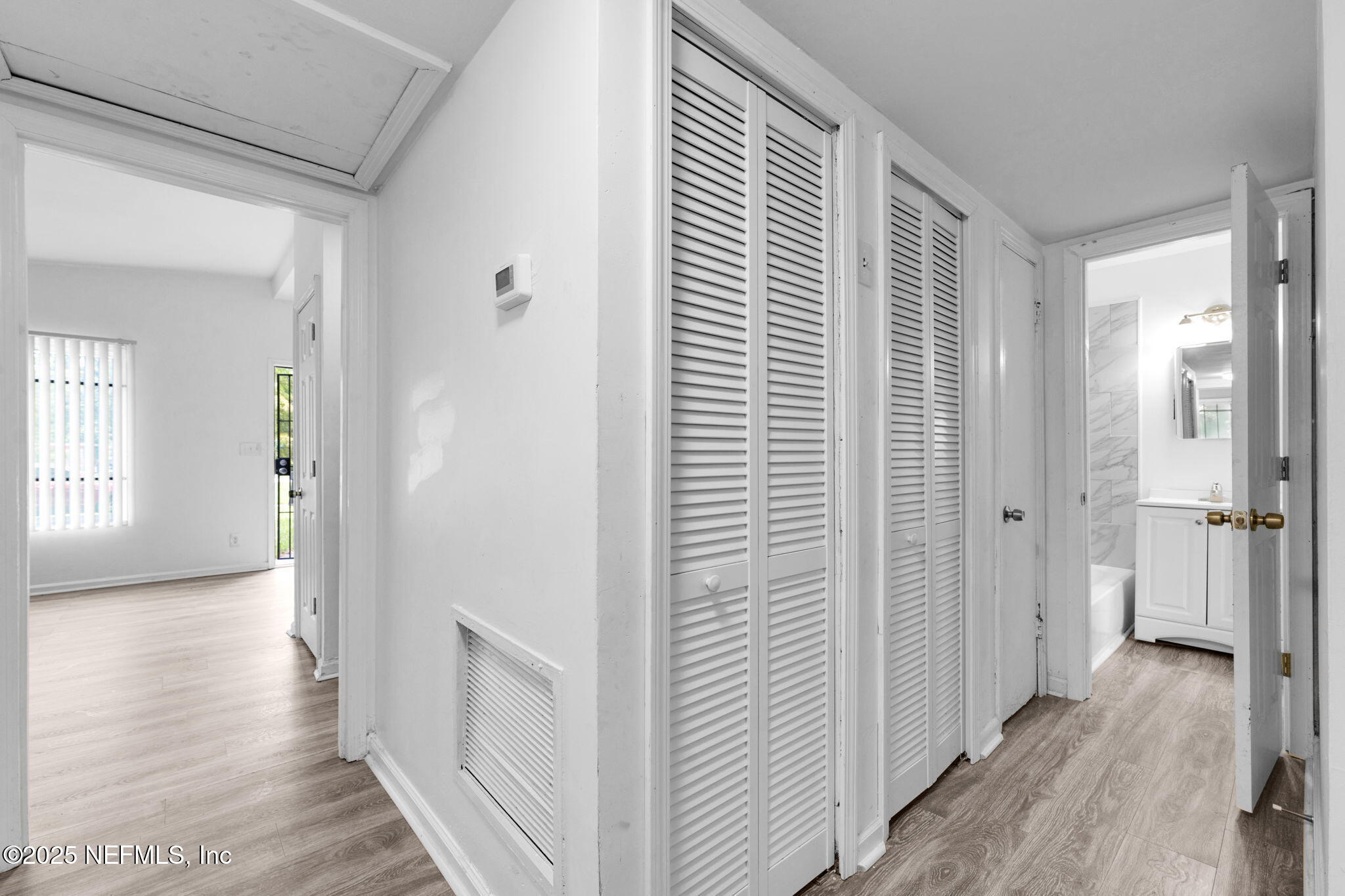 9155 Sibbald Road Jacksonville, FL 32208 - Photo 17 of 22 a view of a hallway with wooden floor and staircase