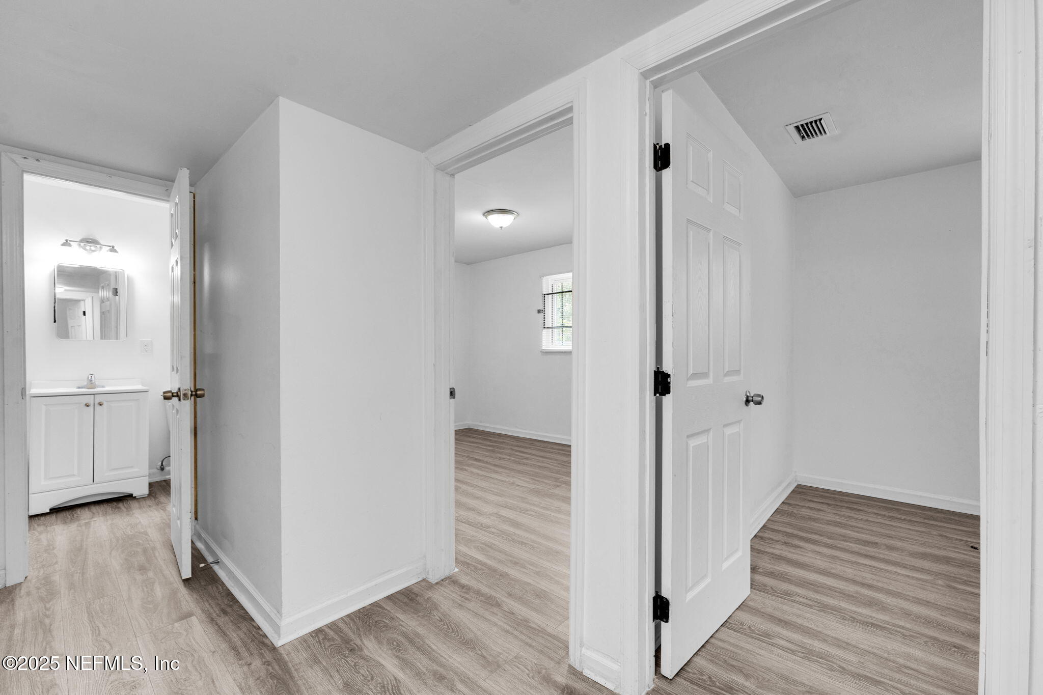 9155 Sibbald Road Jacksonville, FL 32208 - Photo 18 of 22 a view of a hallway with wooden floor