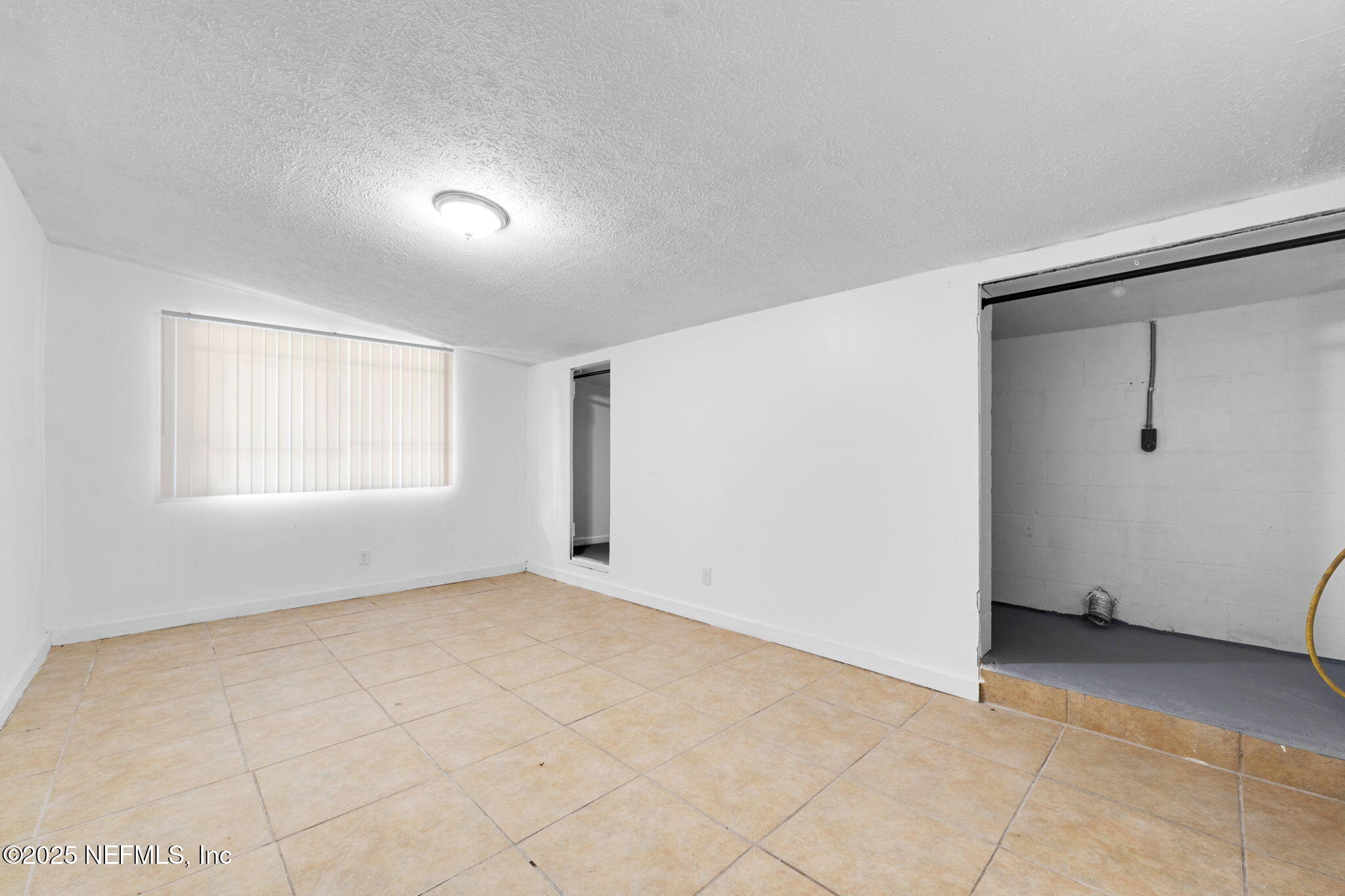 9155 Sibbald Road Jacksonville, FL 32208 - Photo 19 of 22 an empty room with windows