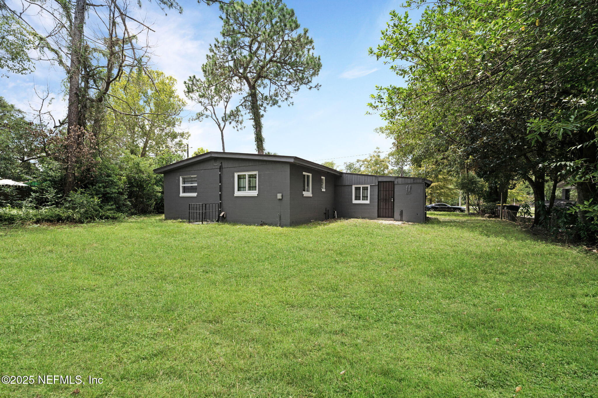 9155 Sibbald Road Jacksonville, FL 32208 - Photo 21 of 22 a view of a house with a yard