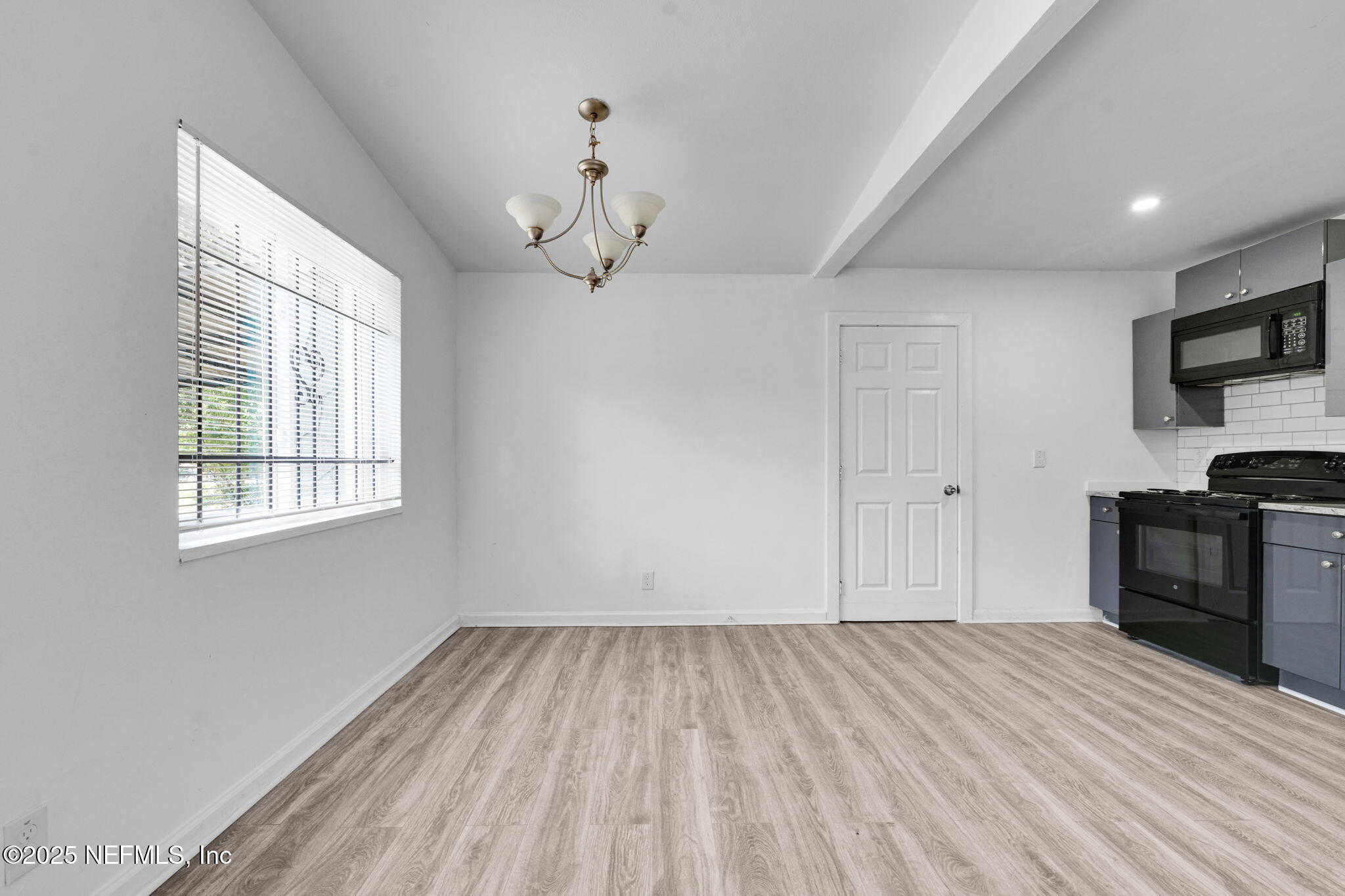 9155 Sibbald Road Jacksonville, FL 32208 - Photo 4 of 22 a view of a room with wooden floor and a window