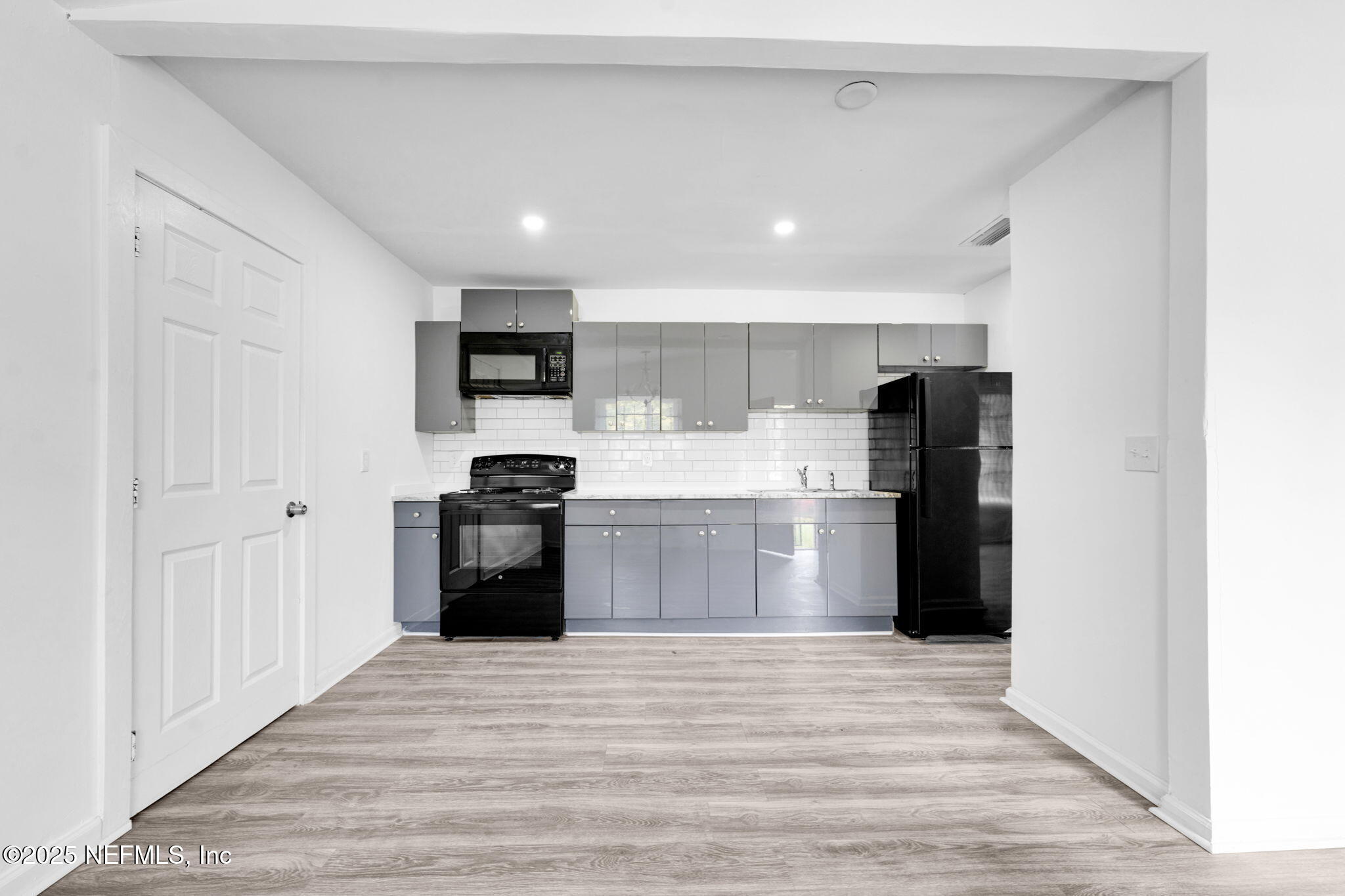 9155 Sibbald Road Jacksonville, FL 32208 - Photo 5 of 22 a kitchen with stainless steel appliances granite countertop a refrigerator and a stove