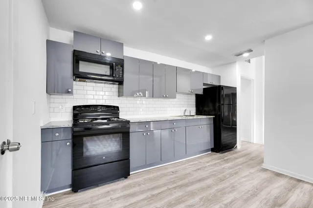 a kitchen with a sink stainless steel appliances and cabinets