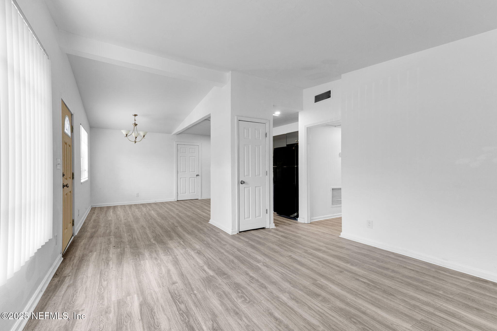 9155 Sibbald Road Jacksonville, FL 32208 - Photo 10 of 22 a view of an empty room with wooden floor and a window