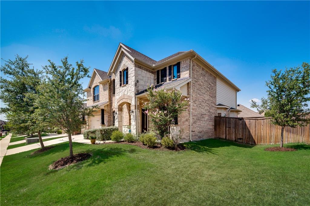 a front view of house with a garden