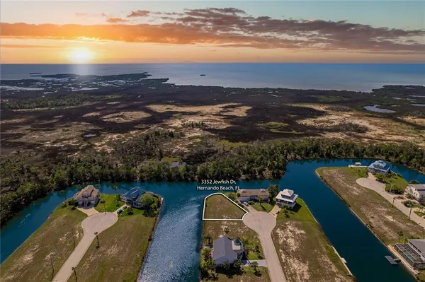 an aerial view of a house with a ocean view