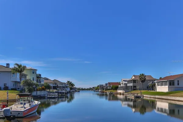 a view of a lake with houses in the background