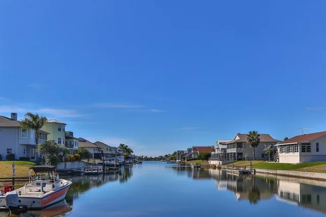 a view of a lake with houses in the background