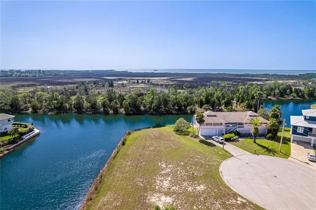 an aerial view of a house with a ocean view