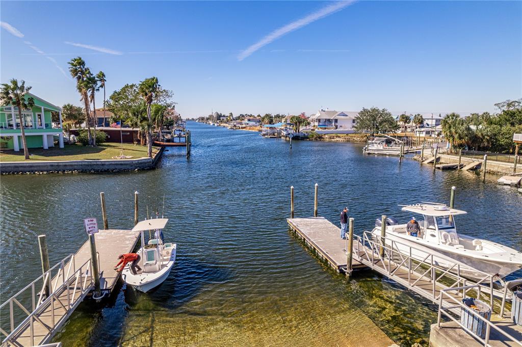 3352 Jew Fish Drive Hernando Beach, FL 34607 - Photo 21 of 23 a view of a lake with boats in front of house