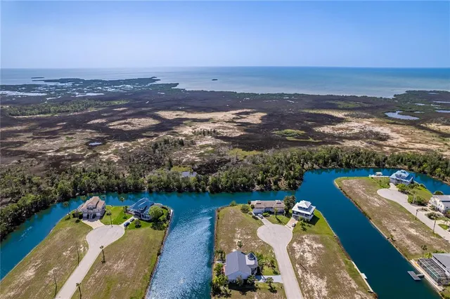 an aerial view of a house with a ocean view