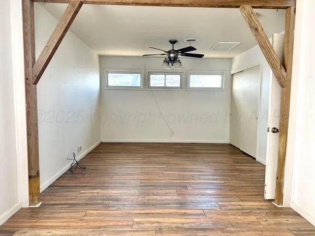 a bathroom with a toilet and a shower curtain