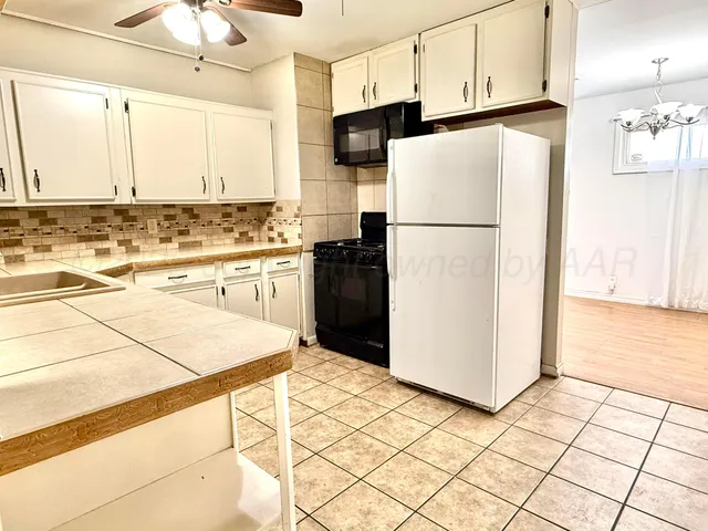 a view of a room with wooden floor and a flat screen tv