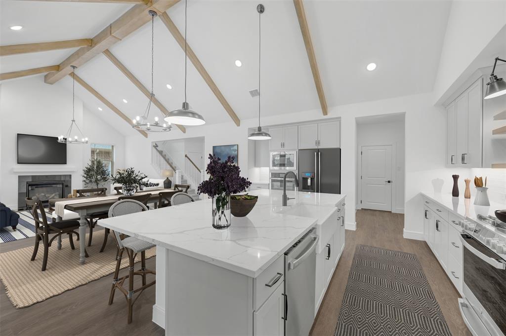 1002 Ashcroft Lane Justin, TX 76247 - Photo 11 of 29 a large white kitchen with a table and chairs
