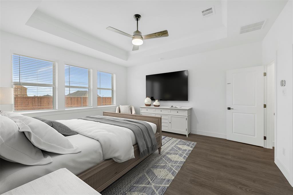 1002 Ashcroft Lane Justin, TX 76247 - Photo 13 of 29 a bedroom with a bed and a flat screen tv