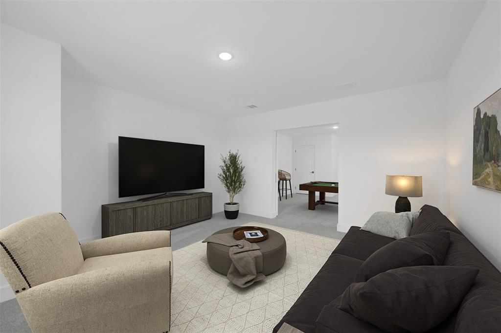 1002 Ashcroft Lane Justin, TX 76247 - Photo 22 of 29 a living room with furniture and a flat screen tv