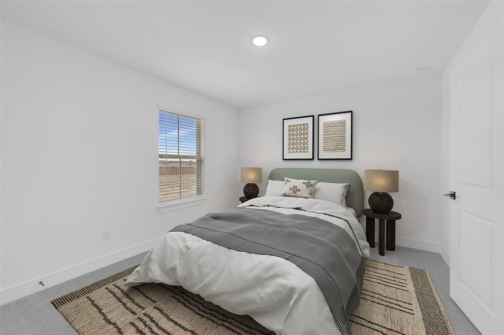 1002 Ashcroft Lane Justin, TX 76247 - Photo 23 of 29 a bedroom with a bed and wooden floor