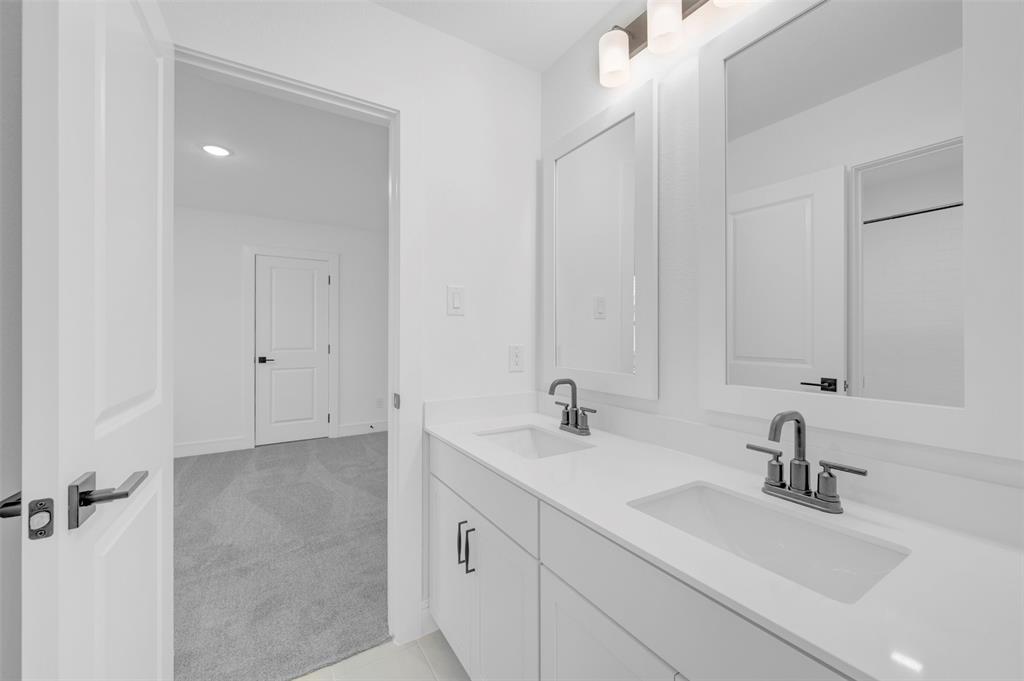 1002 Ashcroft Lane Justin, TX 76247 - Photo 26 of 29 a bathroom with double sink and a mirror