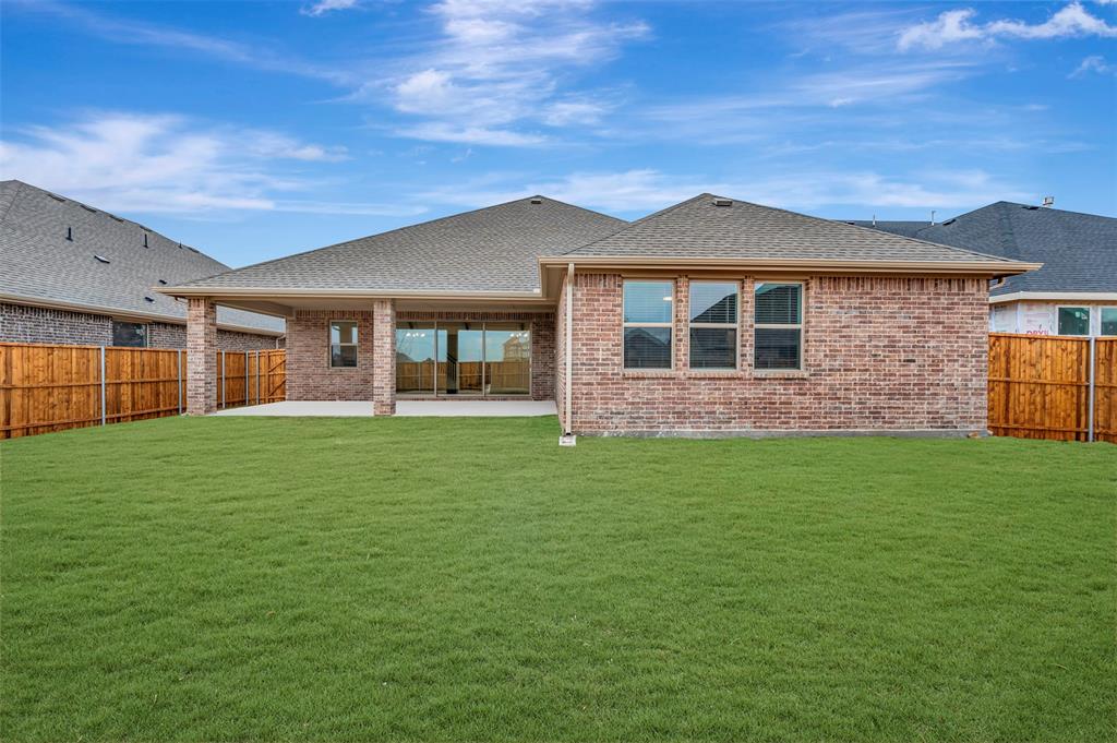 1002 Ashcroft Lane Justin, TX 76247 - Photo 28 of 29 a front view of a house with a garden