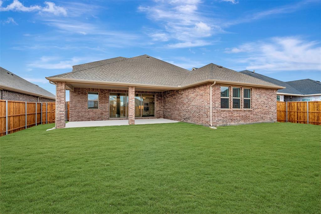 1002 Ashcroft Lane Justin, TX 76247 - Photo 29 of 29 a front view of a house with a garden