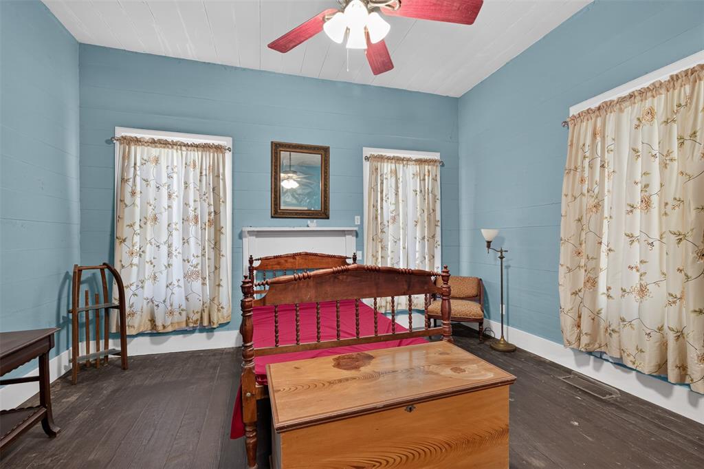 3470 State Rte 531 Dubberly, LA 71024 - Photo 28 of 34 Wood-finish flooring, light blue wall panels, white ceiling, and two windows